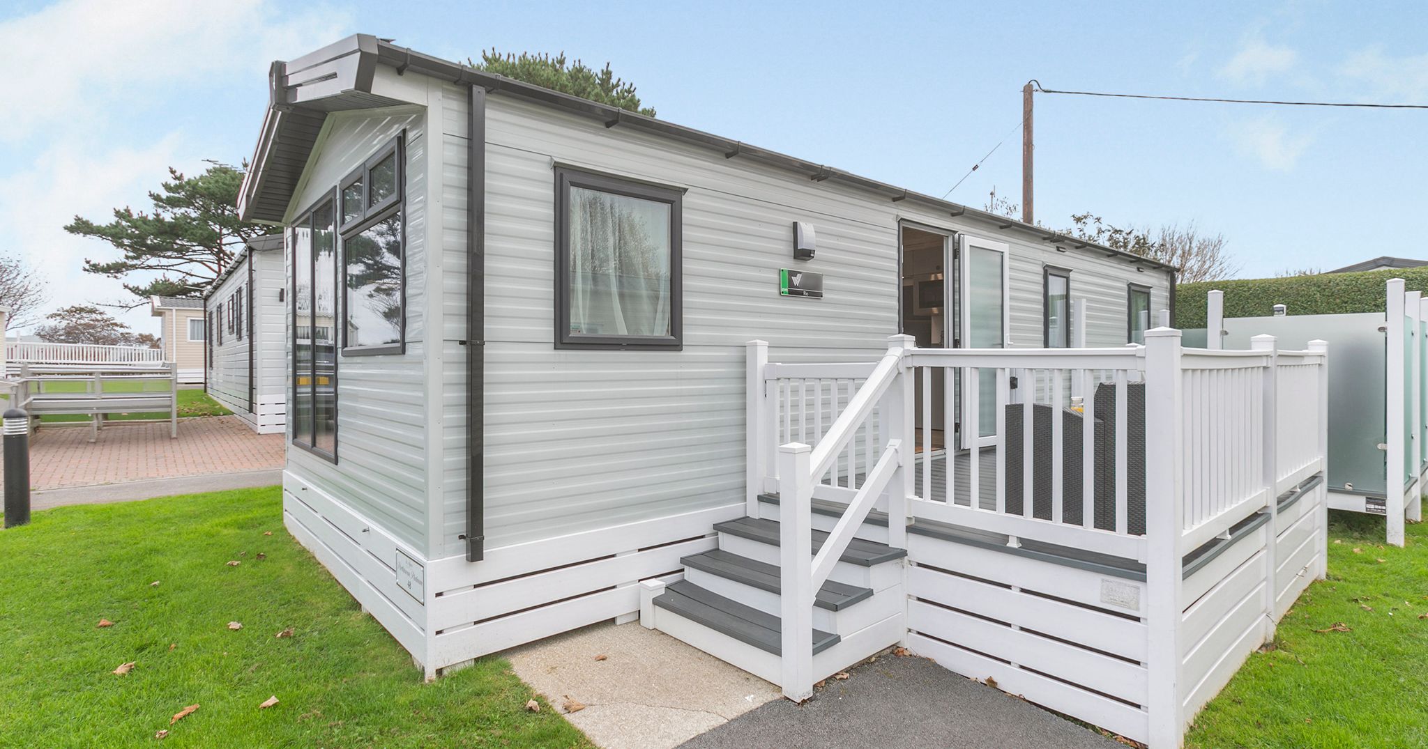 Modern mobile home with steps and white railings