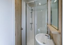 Modern small bathroom with a glass shower enclosure and a white sink