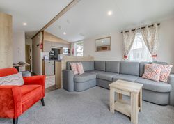 Modern living room with gray sectional sofa and red armchair