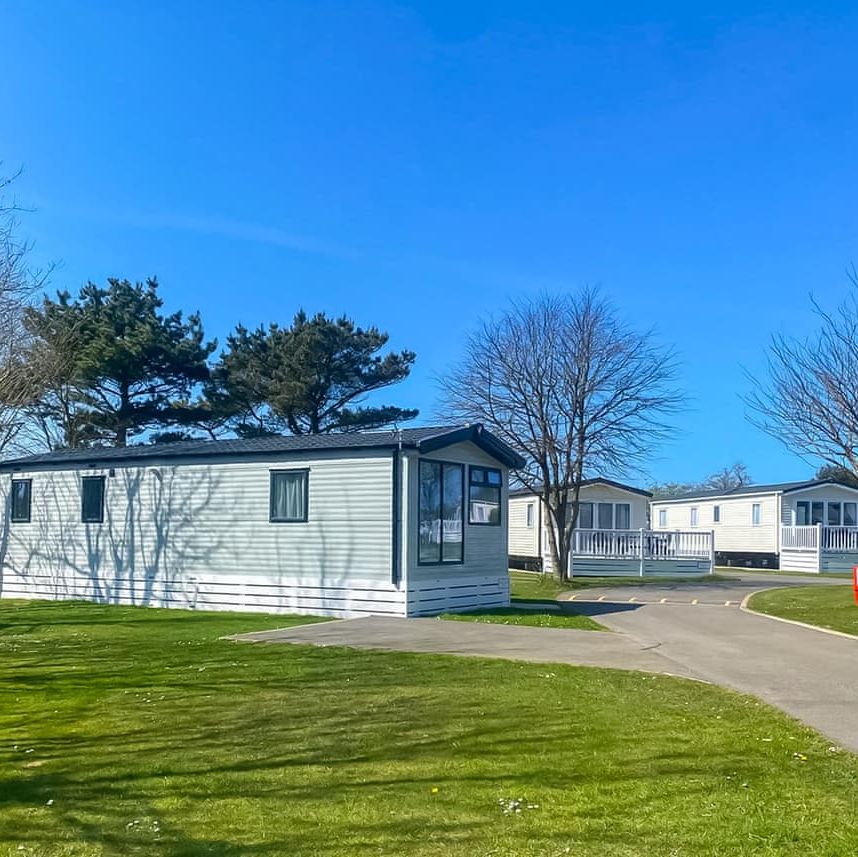 Caravan homes in a holiday park on a sunny day.