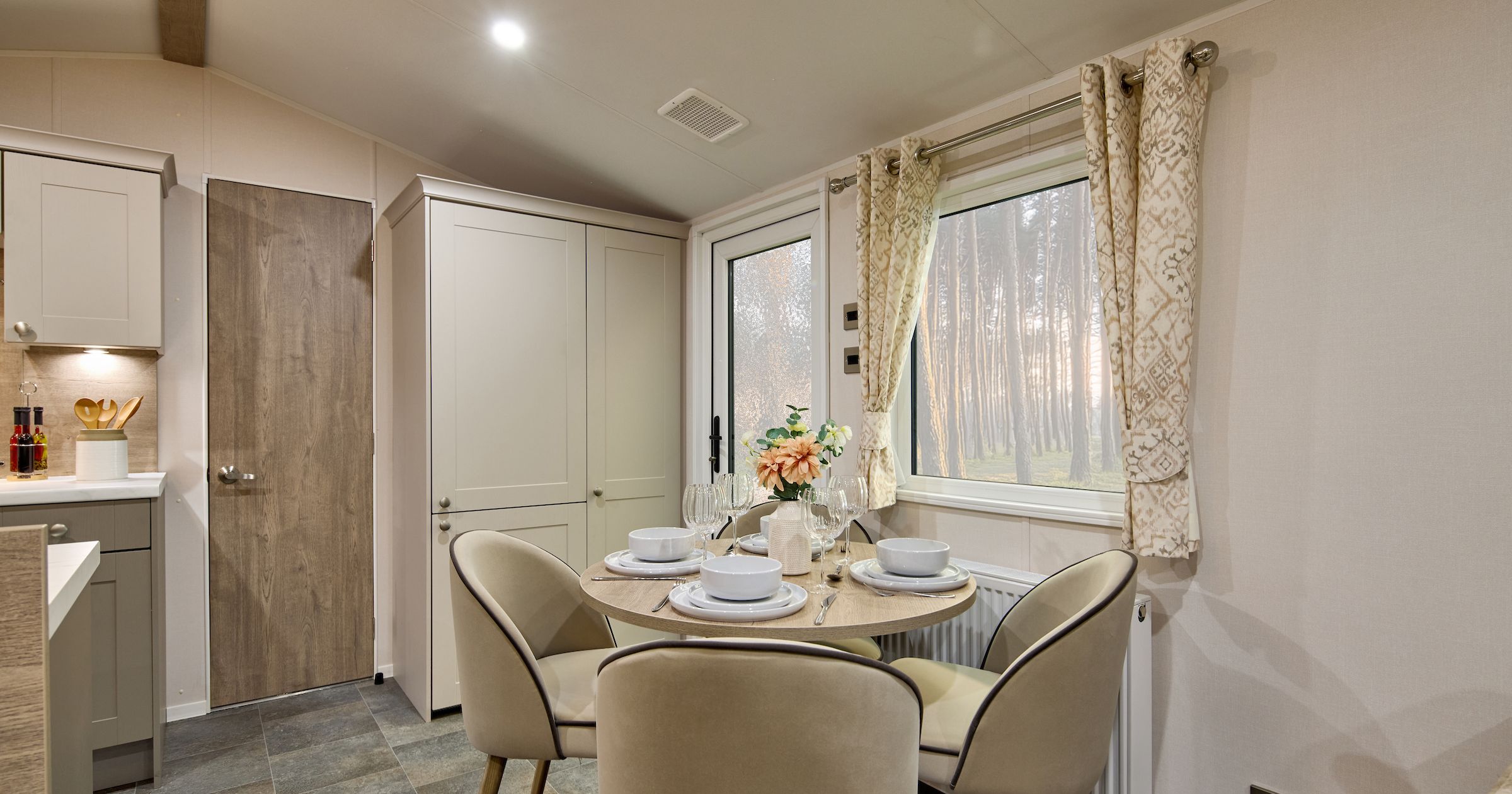Modern dining area with round table and four chairs in a cozy kitchen setting
