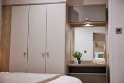 Bedroom wardrobe and vanity with mirror and toiletries