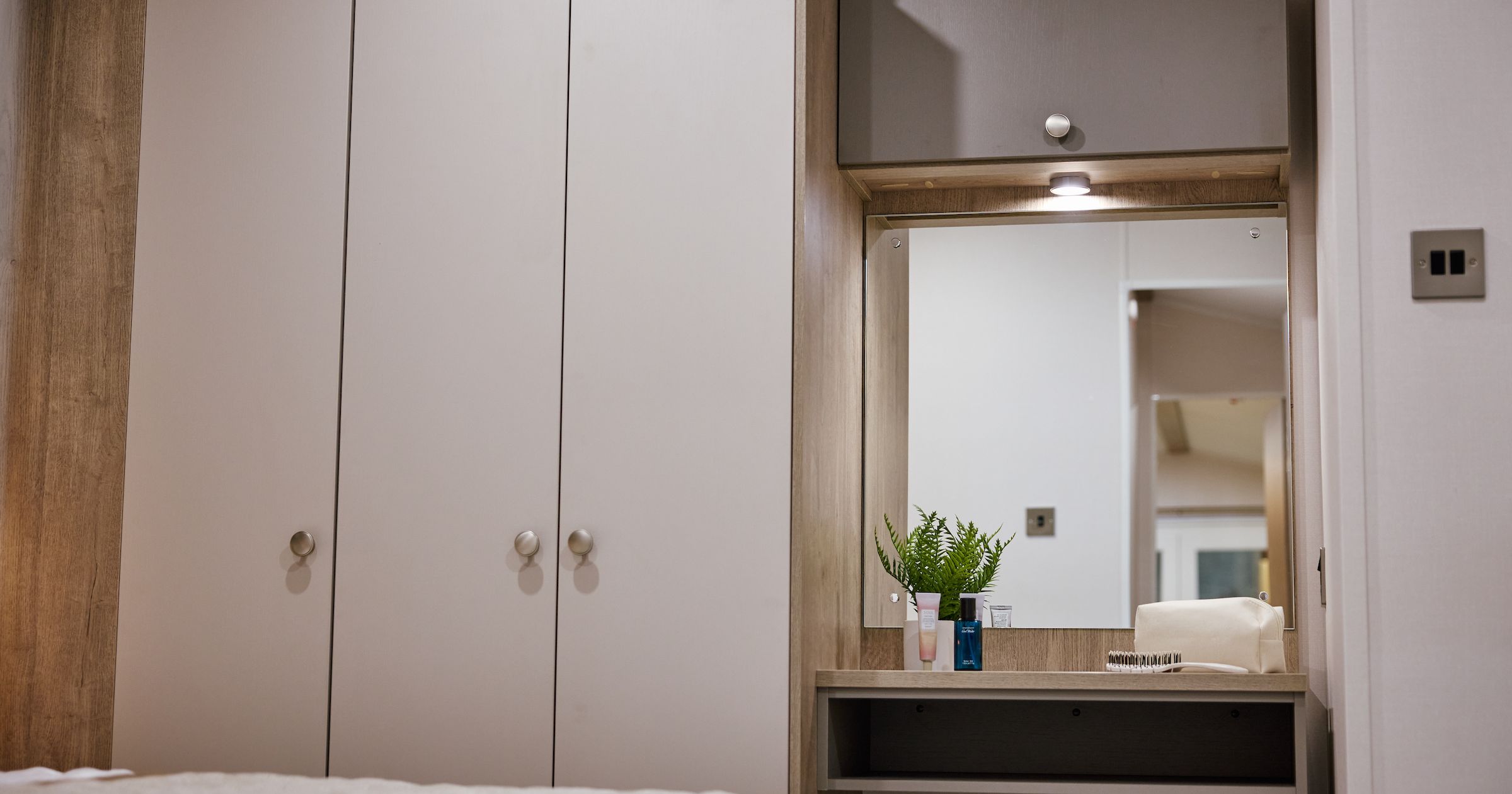 Bedroom wardrobe and vanity with mirror and toiletries