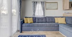 Fistral lounge with grey sofa and yellow pillows