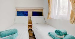 Twin beds with blue towels