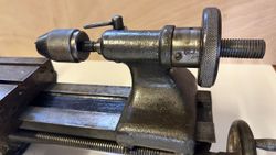 Close-up of a metal lathe tailstock with a drill chuck attached