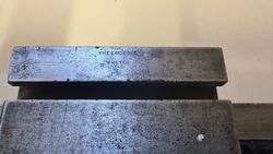 Close-up of a metal object with the words 'EX ENGINEERING EXETER' engraved on it.