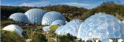 Geodesic domes of the Eden Project surrounded by greenery and hills