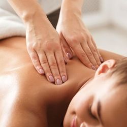 Person receiving a back massage at a spa