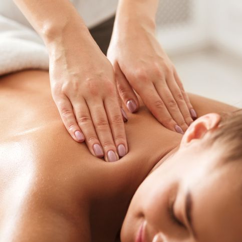 Person receiving a back massage at a spa
