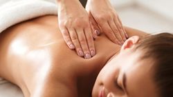 Person receiving a back massage at a spa