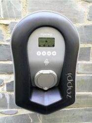 Zappi electric vehicle charging unit mounted on a stone wall
