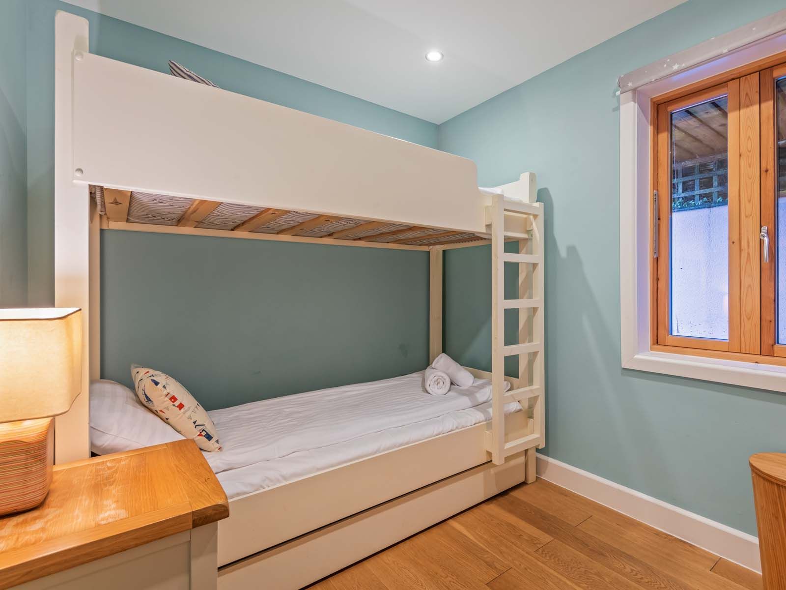 Cozy bedroom with bunk beds and a wooden window