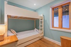 Cozy bedroom with bunk beds and a wooden window