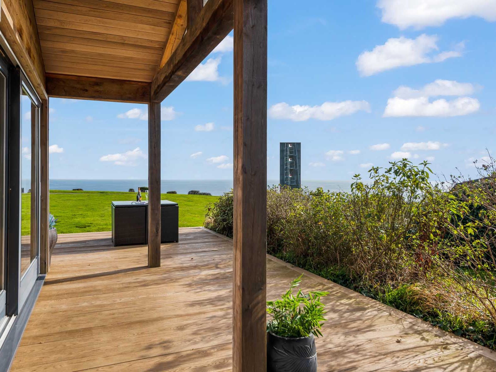 Wooden patio with sea view and outdoor furniture