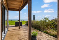 Wooden patio with sea view and outdoor furniture