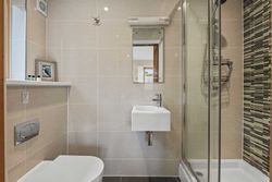 Modern small bathroom with shower, sink, and toilet