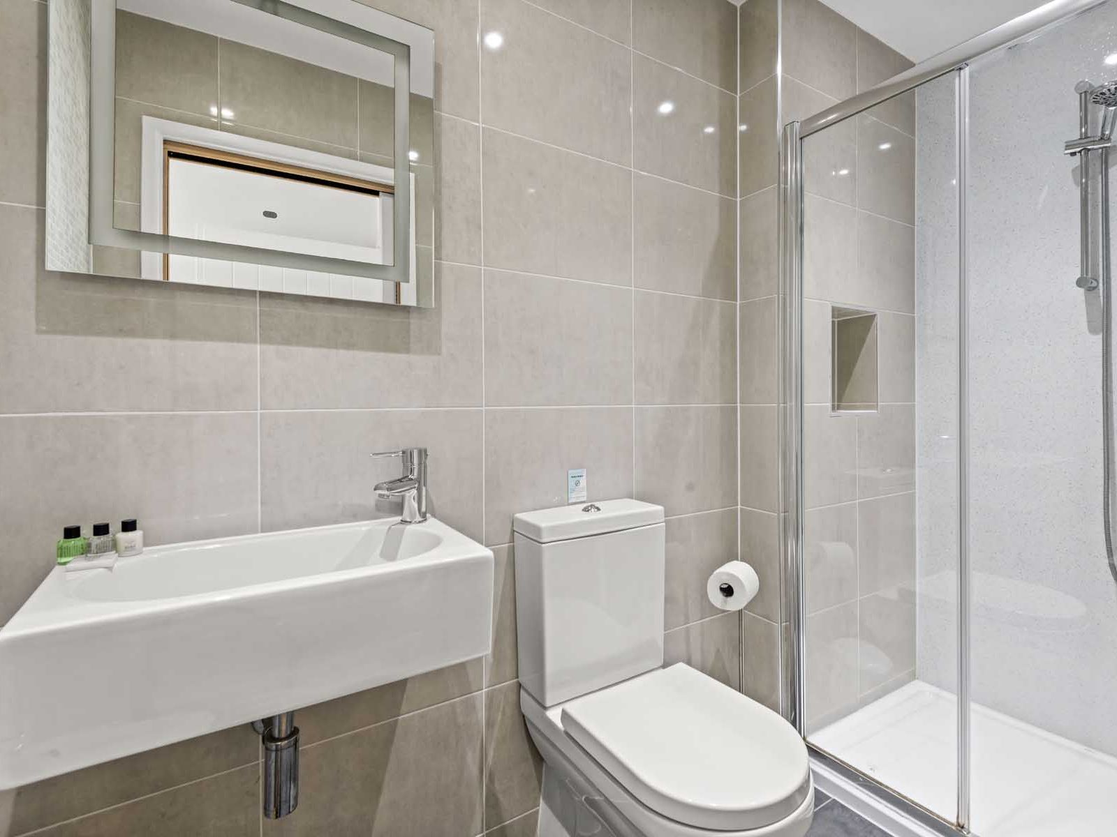 Modern bathroom with shower, toilet, and sink