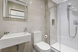 Modern bathroom with shower, toilet, and sink