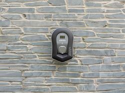 Electric vehicle charger mounted on a stone wall