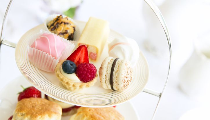 Assorted afternoon tea pastries and sweets on a tiered tray
