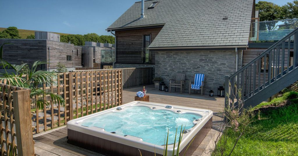 Modern house with outdoor hot tub and wooden deck