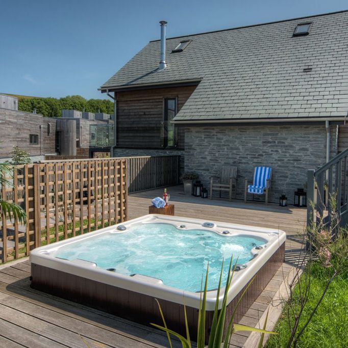 Modern house with outdoor hot tub and wooden deck