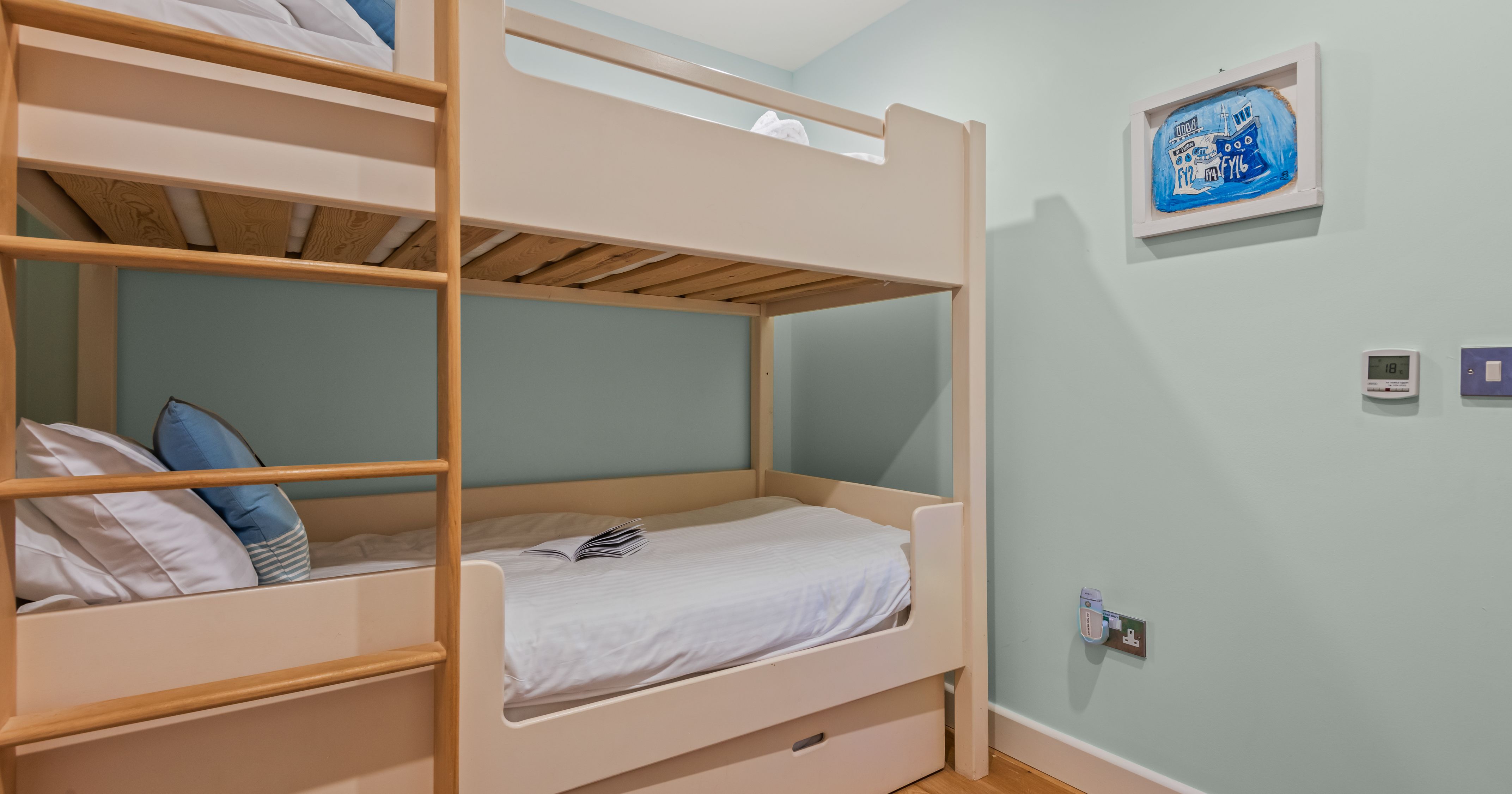 Cozy bedroom with bunk beds and light blue walls