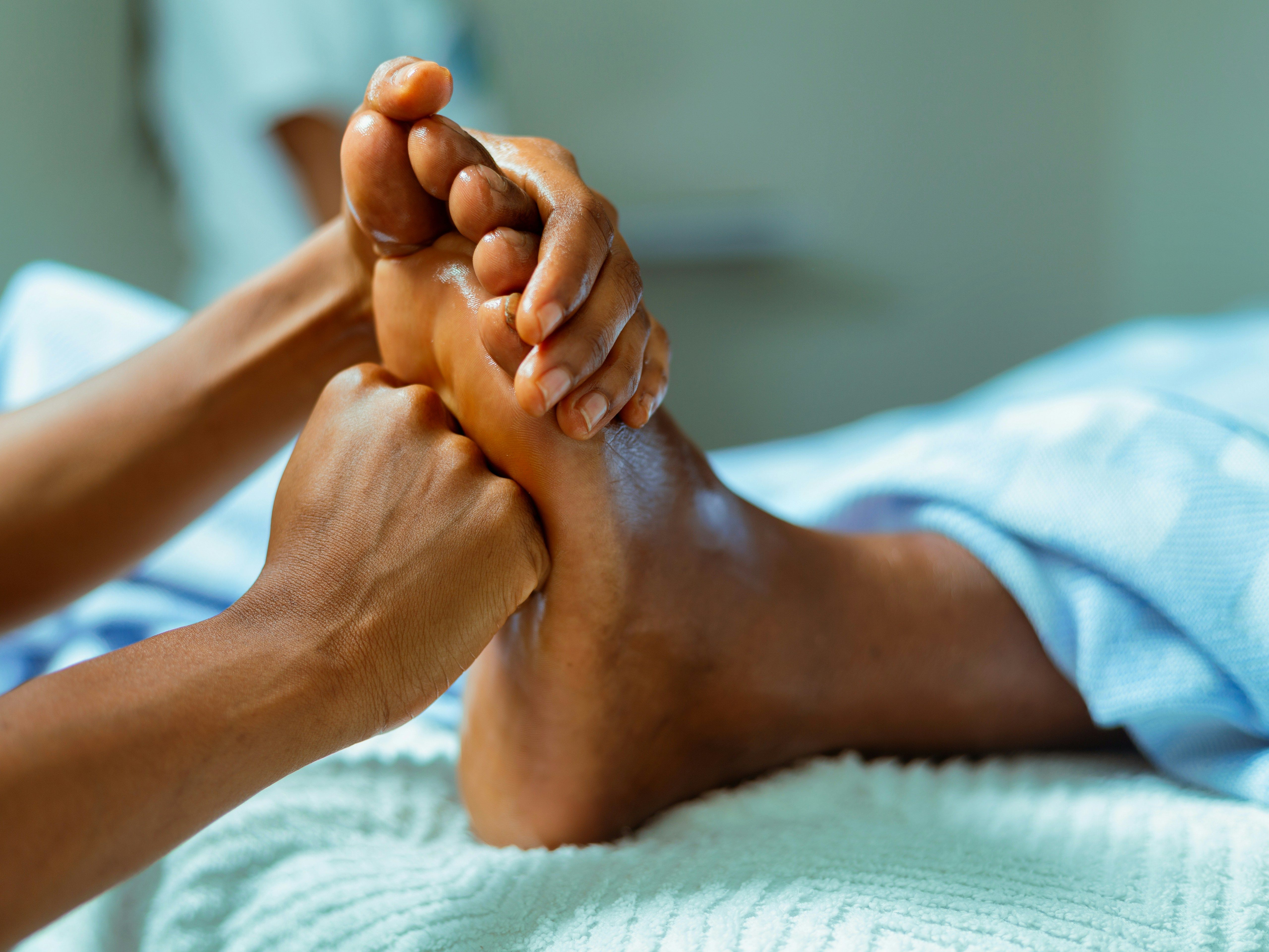 close-up of a person receiving a foot massage