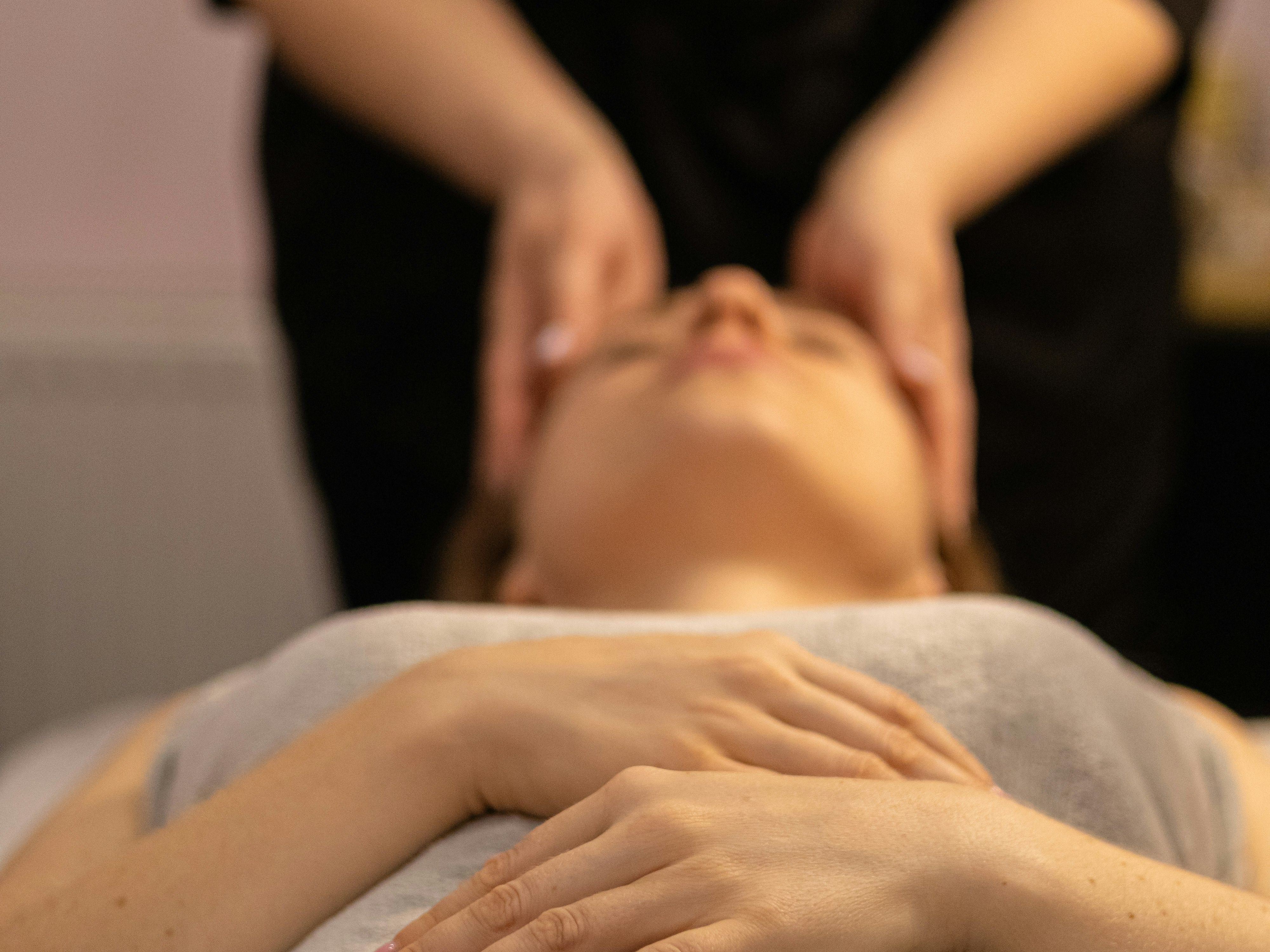Person receiving a relaxing head massage at a spa.