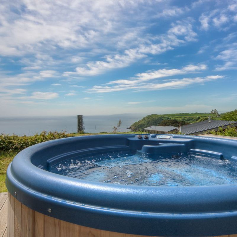 Outdoor hot tub with scenic coastal view