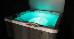 Hot tub glowing at night with blue water lights