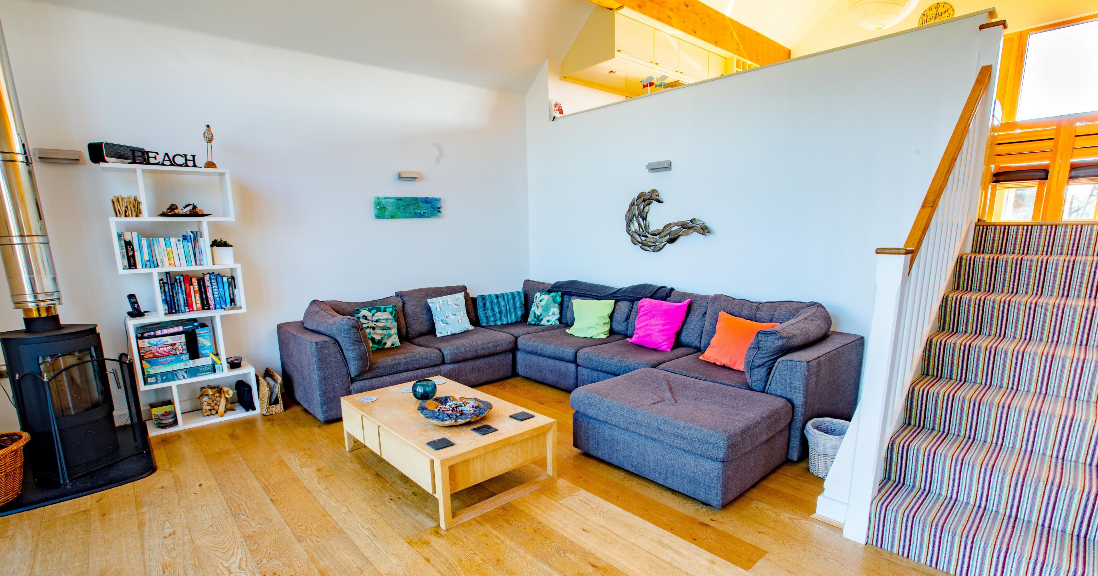 Modern living room with grey sectional sofa and colorful pillows