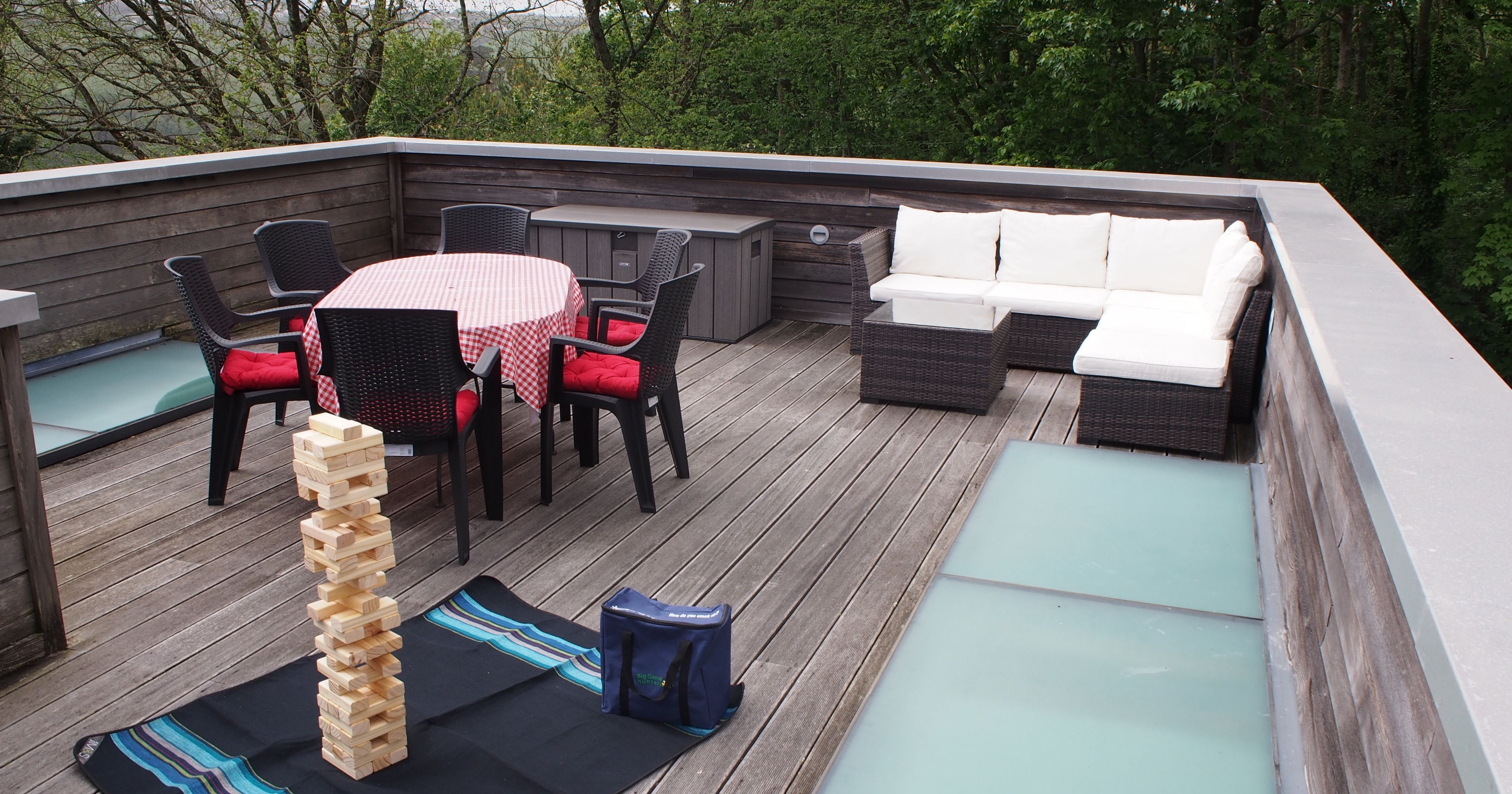 Outdoor rooftop patio with seating area and Jenga game