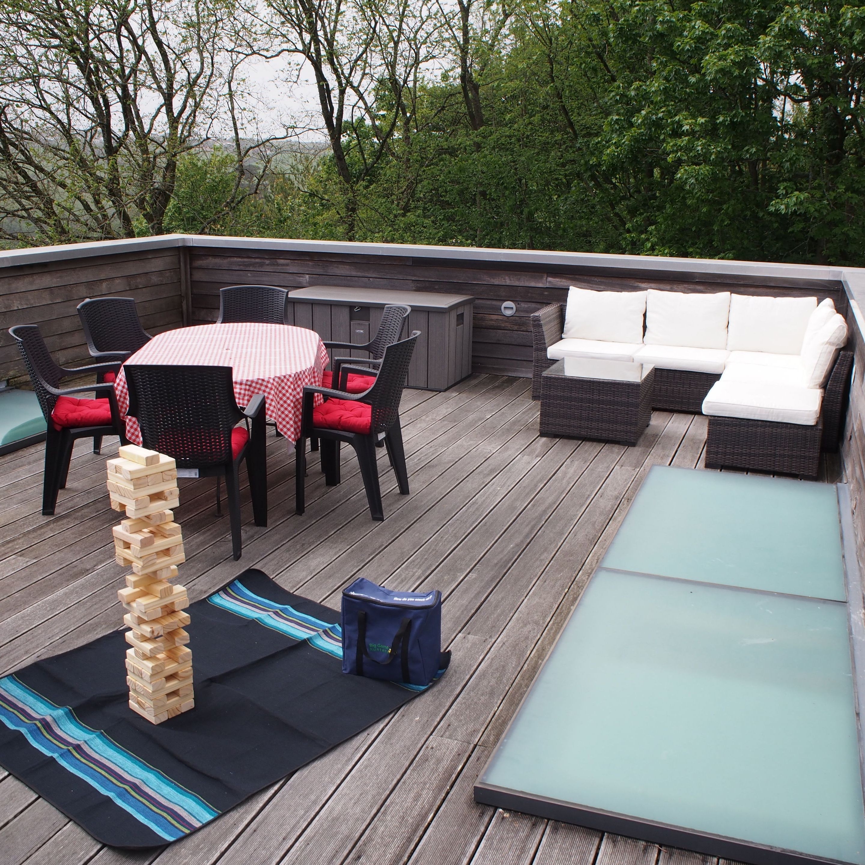 Outdoor rooftop patio with seating area and Jenga game