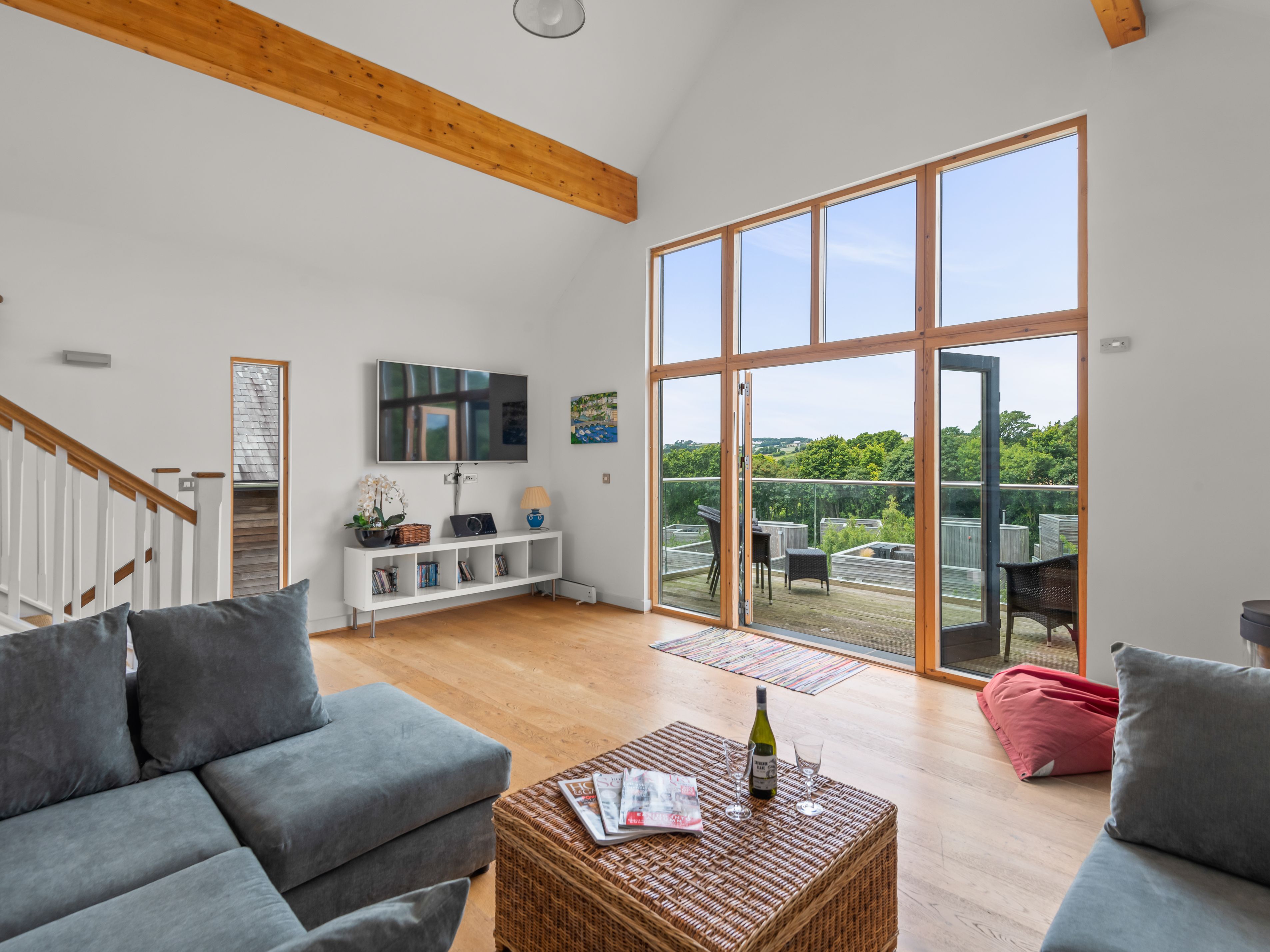Modern living room with large windows and outdoor patio view