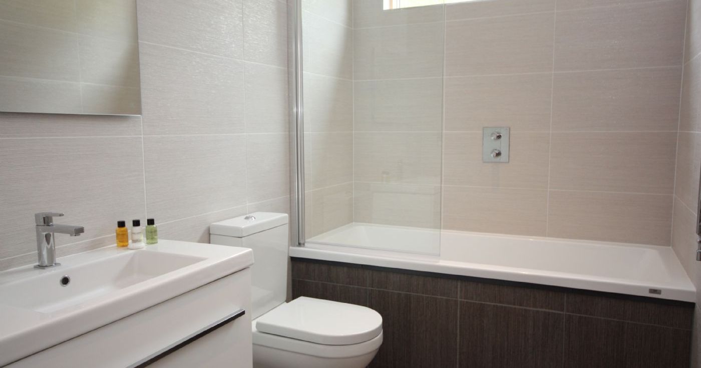 Modern bathroom with bathtub, toilet, and sink
