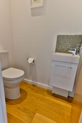 Small modern bathroom with toilet and compact sink