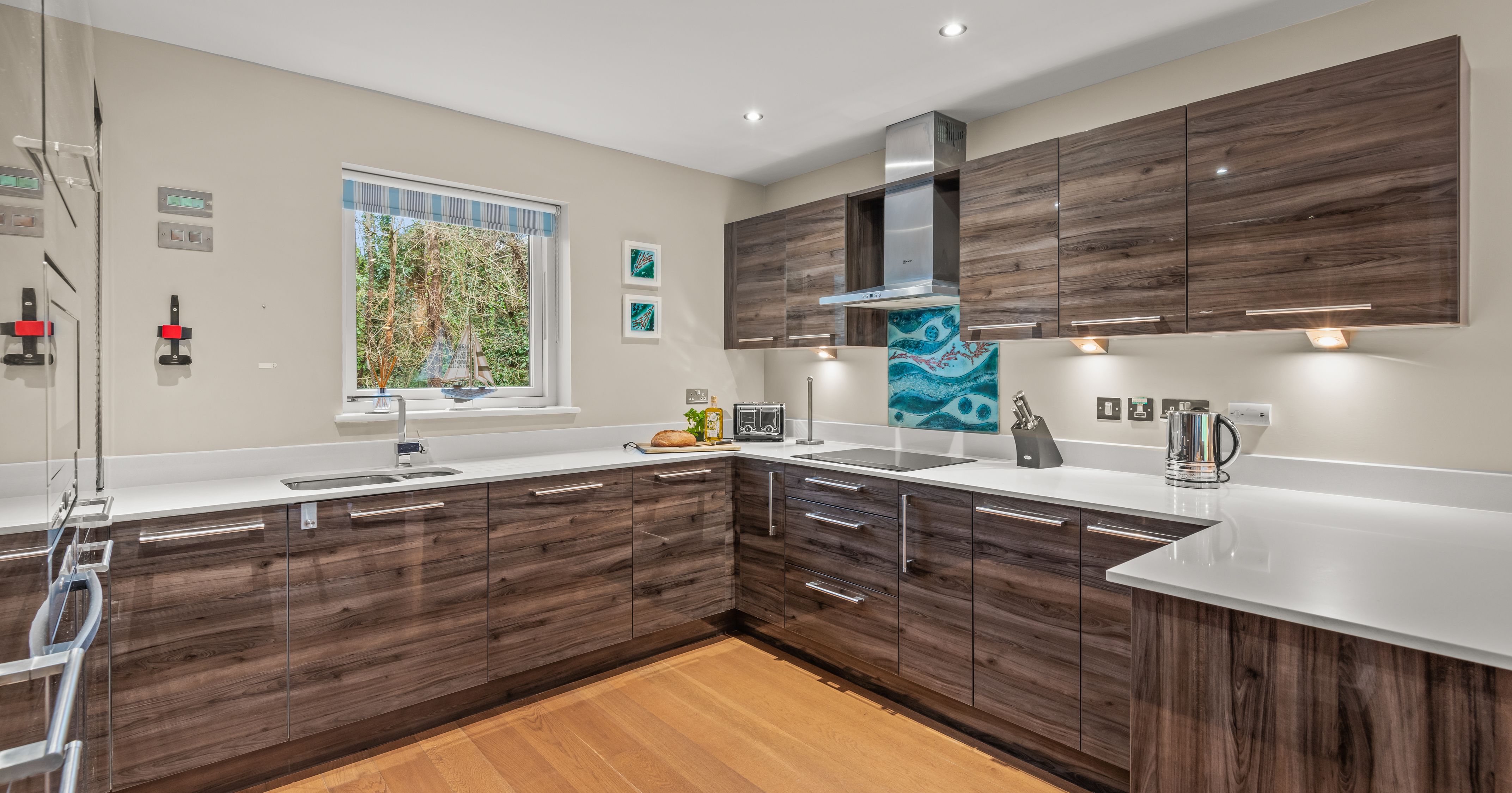 Modern kitchen with glossy wood cabinets and white countertops