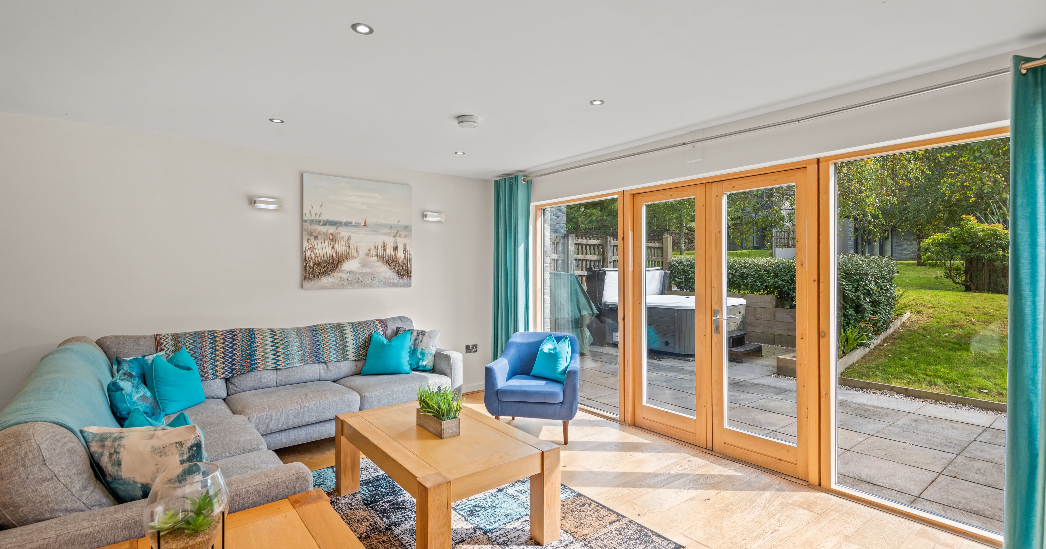 Modern living room with large glass doors opening to a garden patio