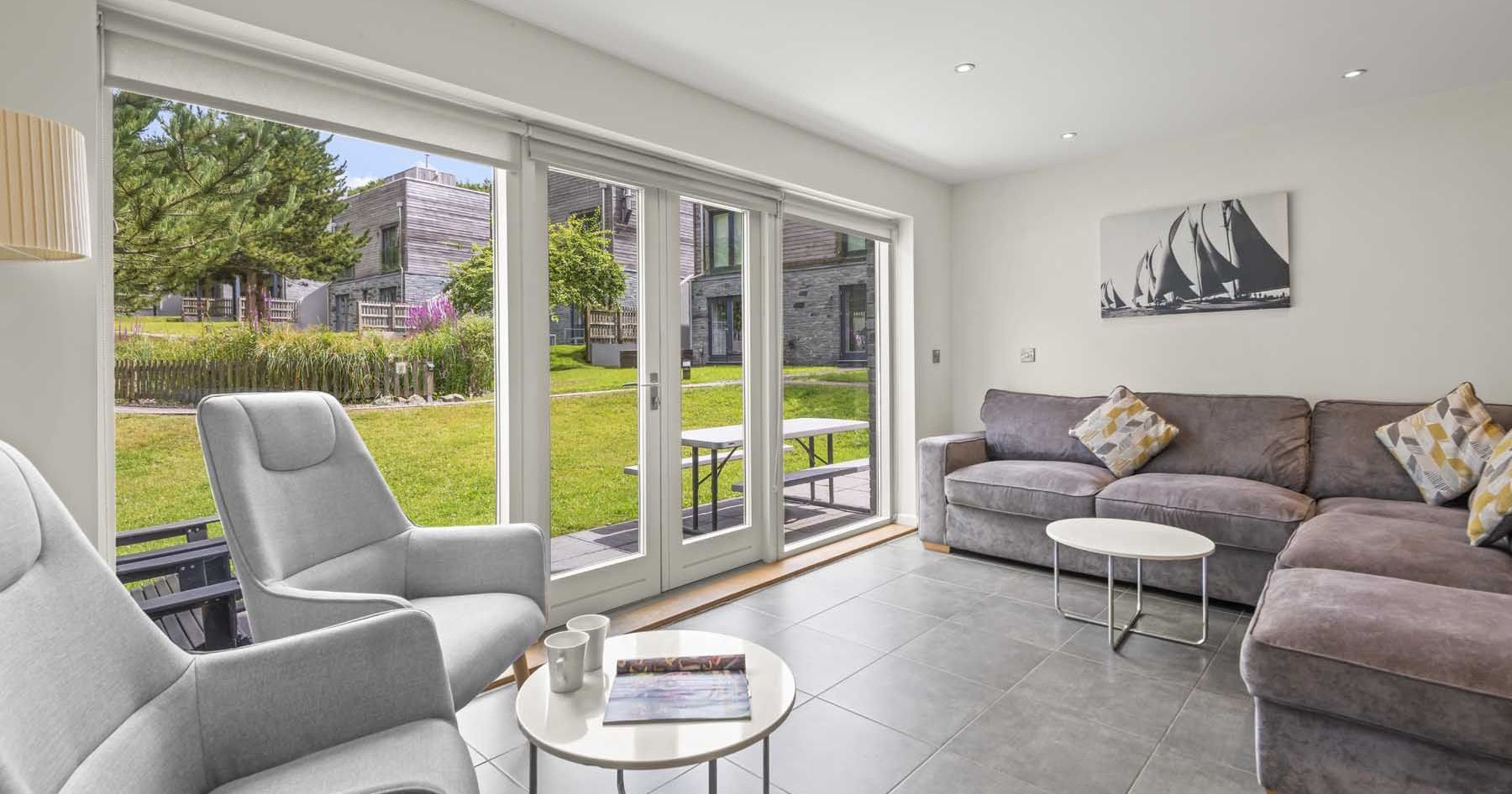 Modern living room with large windows and garden view