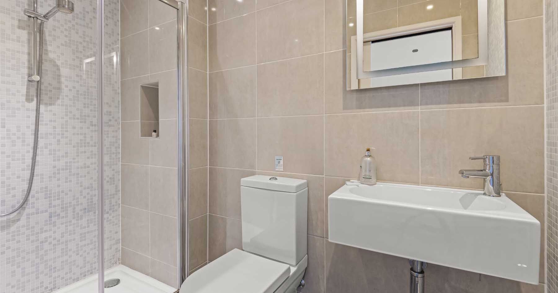 Modern bathroom with shower, toilet, and sink