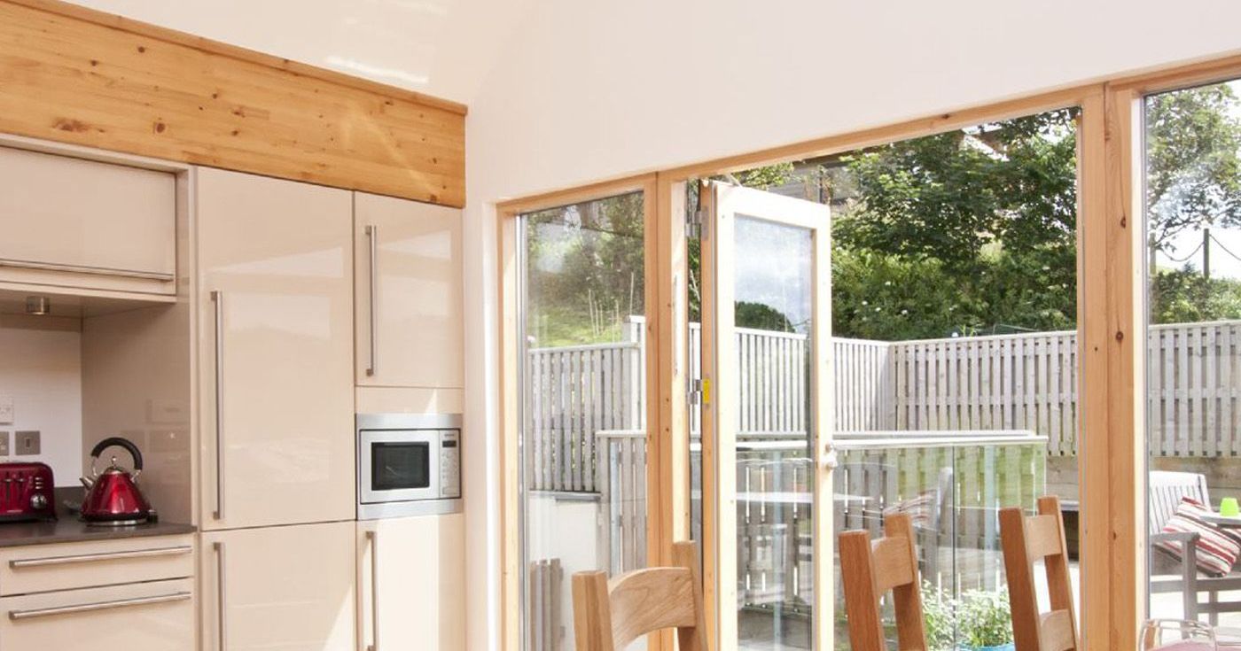Bright modern kitchen with glass doors opening to a patio