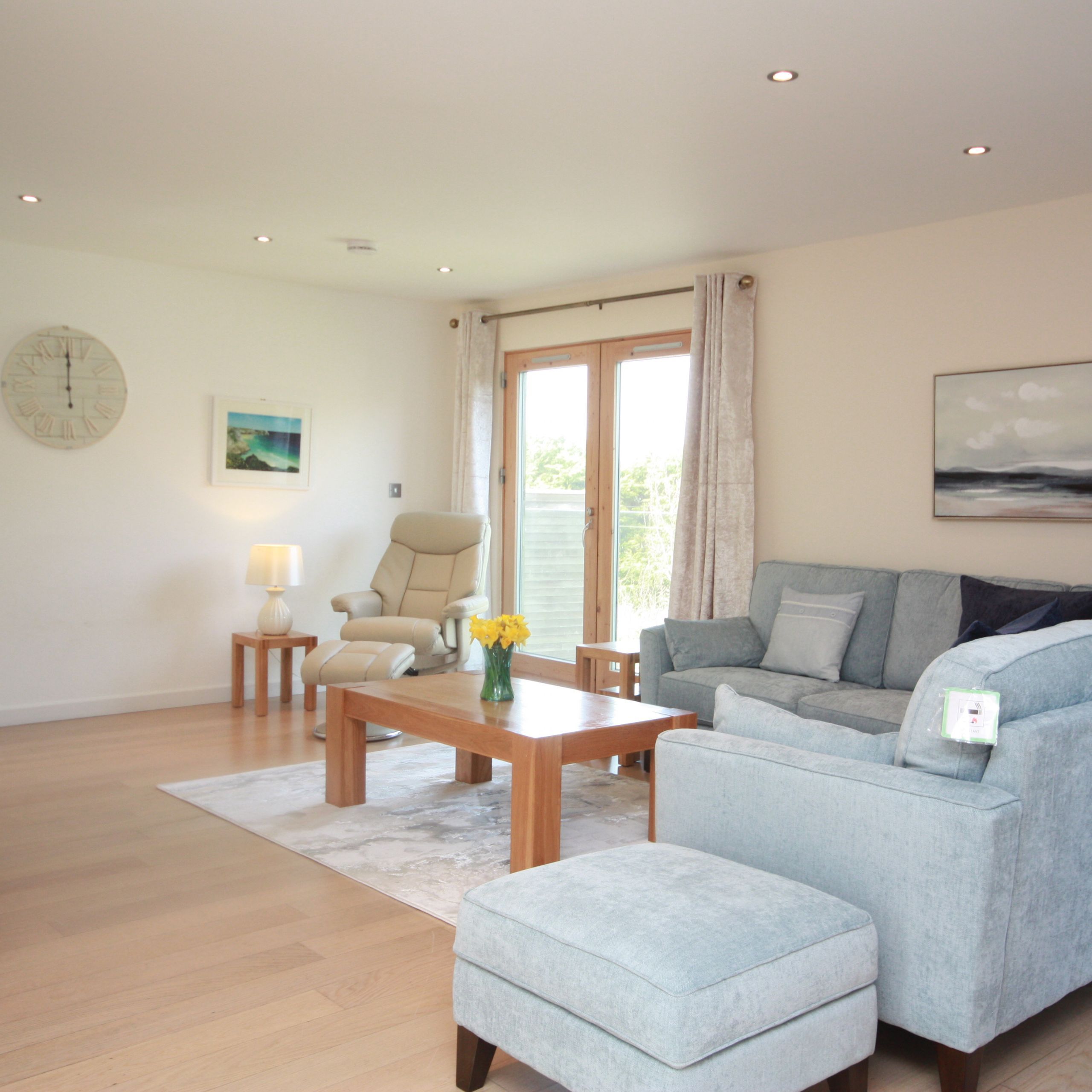 Modern living room with light blue sectional sofa and wooden furniture