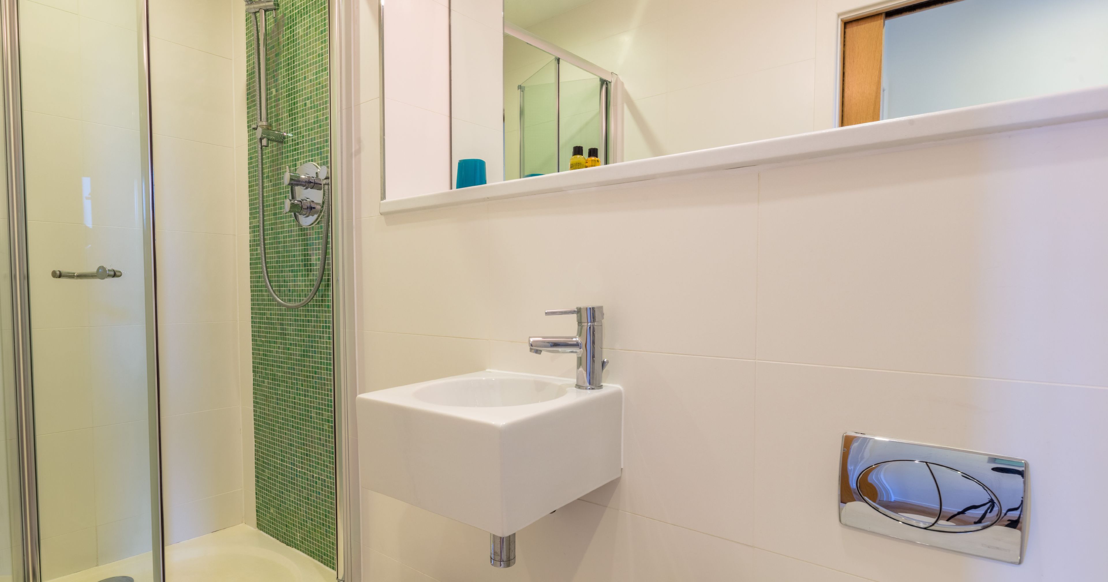 Modern bathroom with shower, sink, and mirror