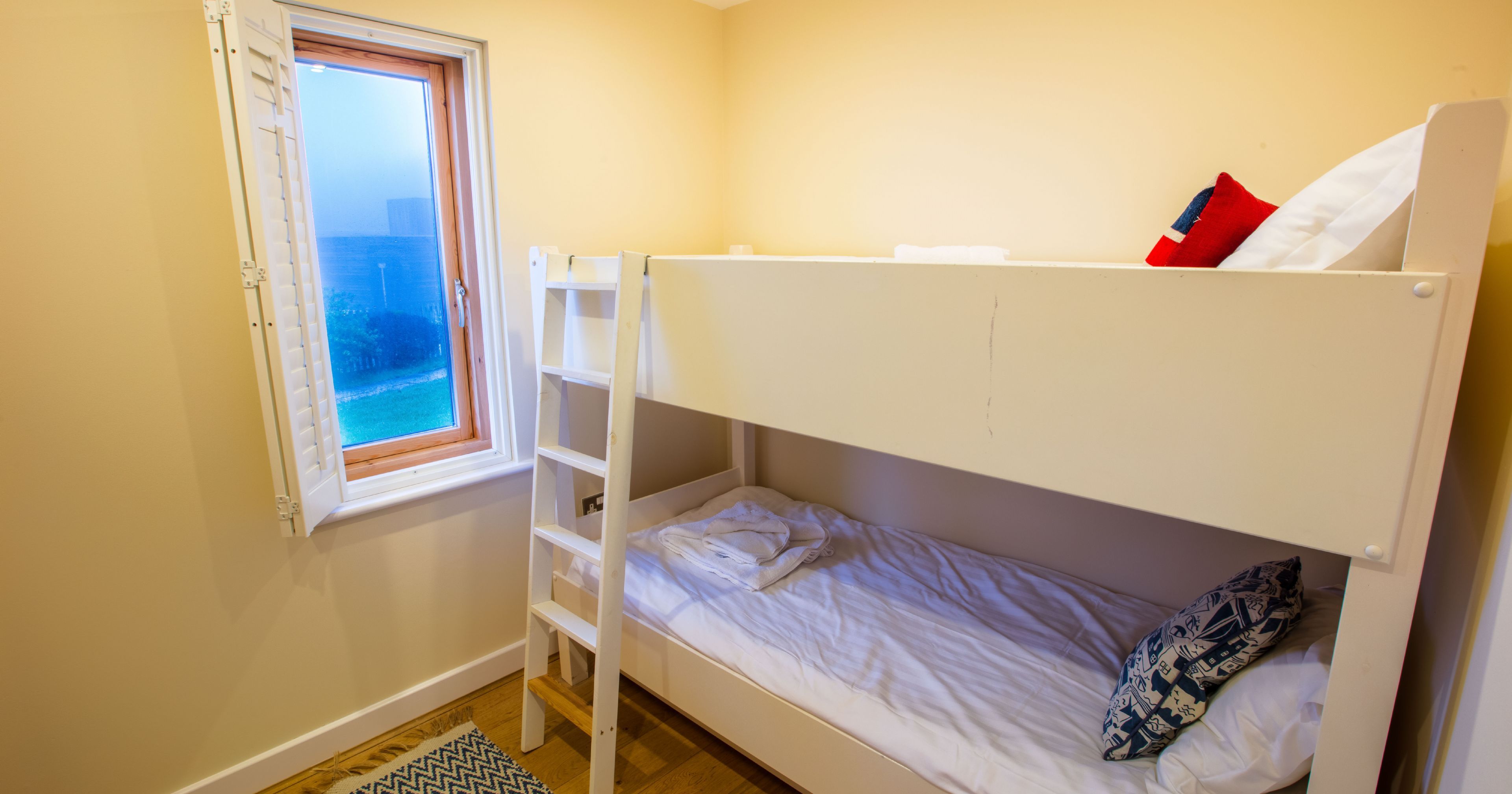 Small bedroom with bunk beds and an open window