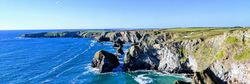Rocky cliffs and blue ocean under a clear sky