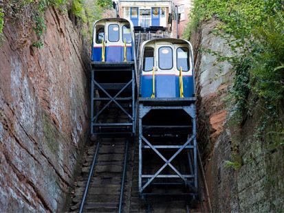 Two funicular railway cars on a steep cliffside track