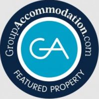 GroupAccommodation.com featured property badge with GA initials