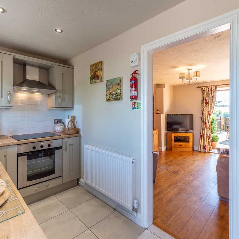 View from a kitchen into a living room in a cozy home
